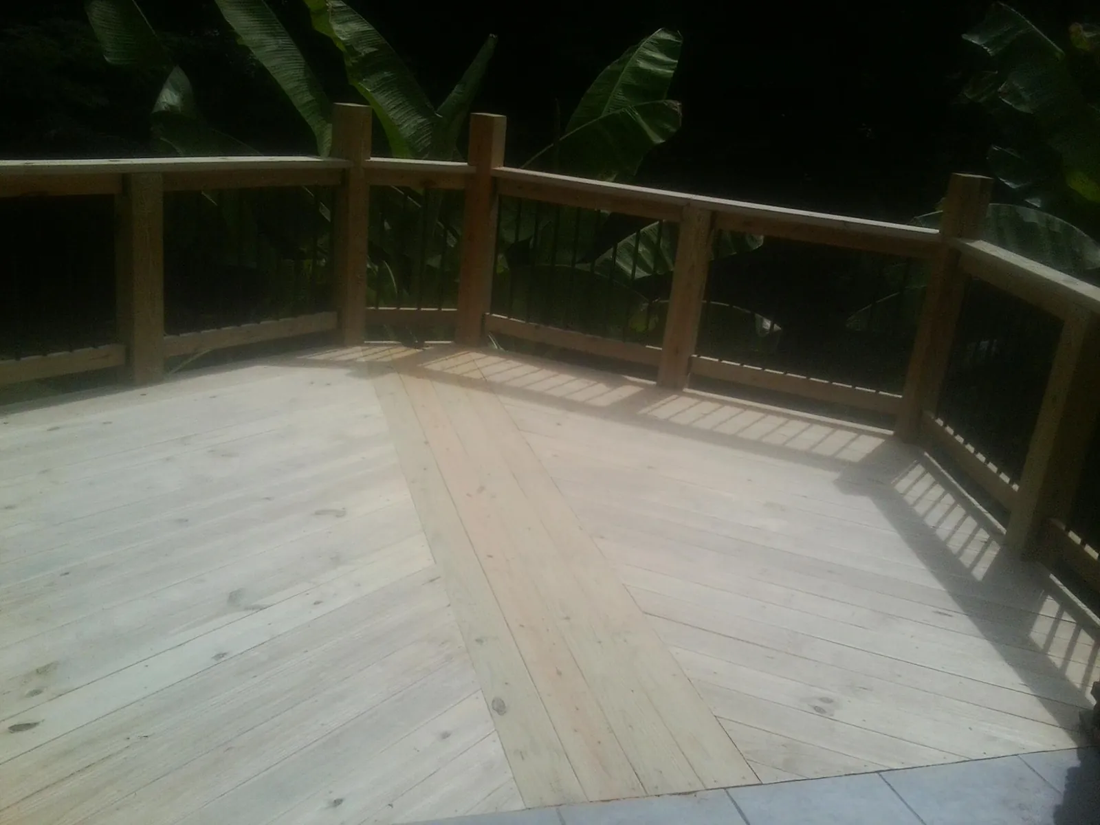 New wood deck and railing built off the back of a home in Springfield